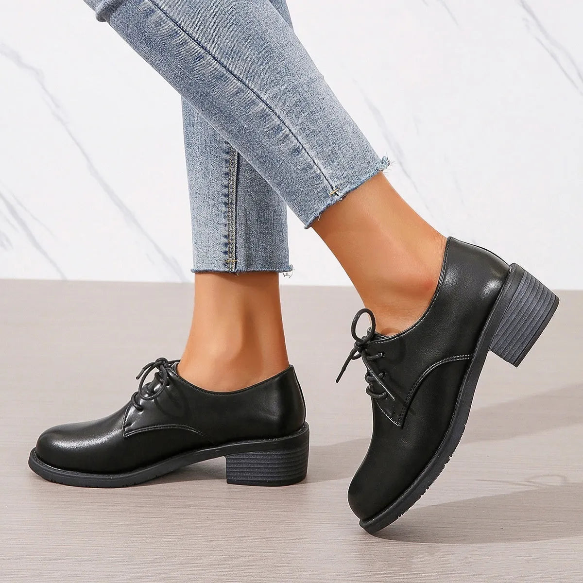 Black women's low-top work shoes with a chunky rubber heel and pointed toe.