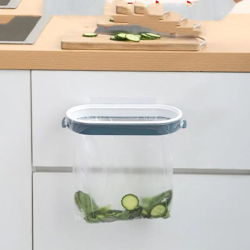 A blue plastic garbage bag storage rack mounted inside a kitchen cabinet door.