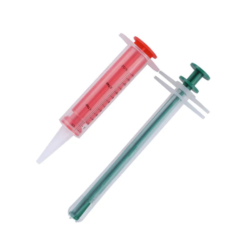 Two silicone pet pill shooters, one larger and one smaller, with soft tips and push rods.