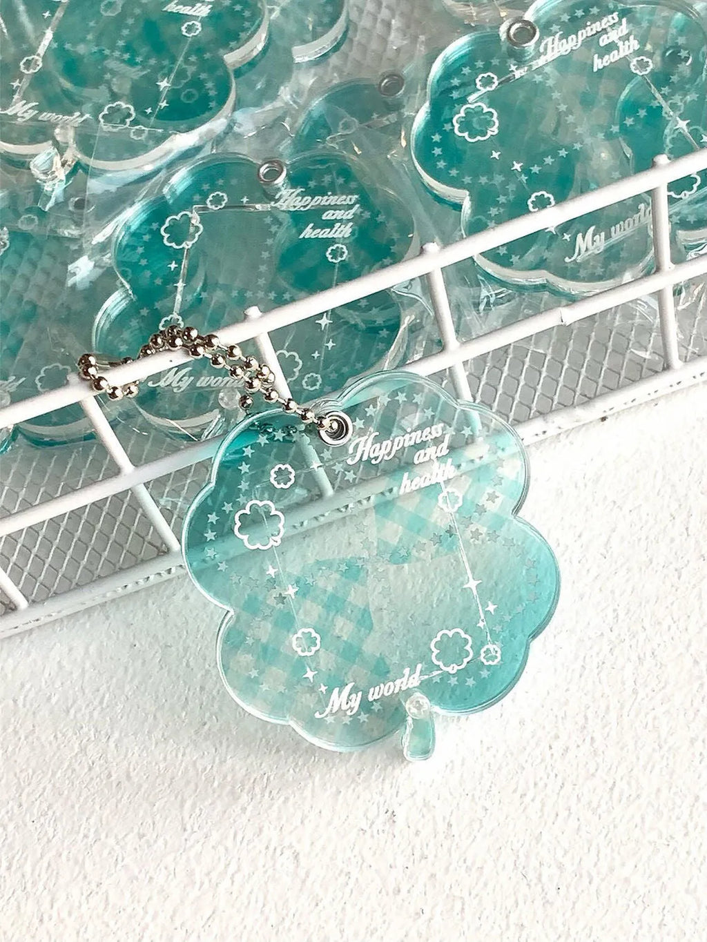 Acrylic four-leaf clover phone pendant keychain in blue, green, or mint green.