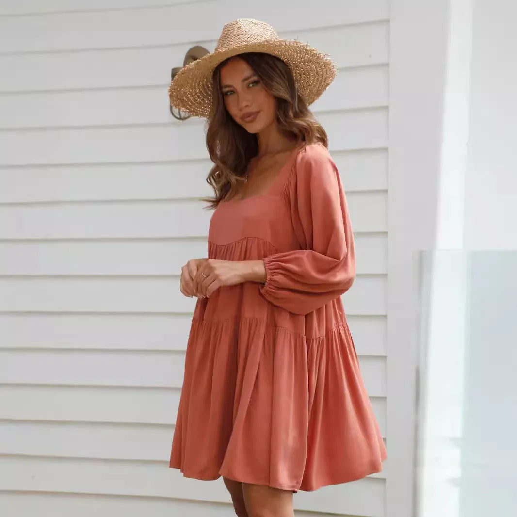 Children's orange backless pullover dress with square collar and puff sleeves showing A-line skirt silhouette