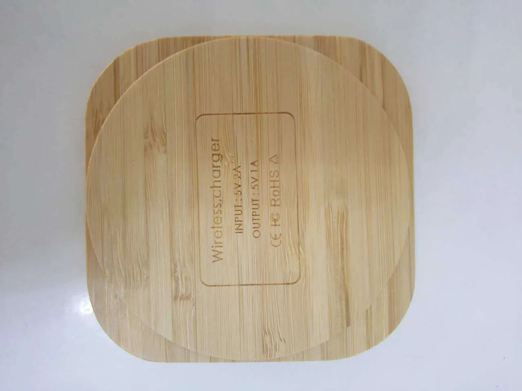 Square brown bamboo 5W wireless charging pad on a wooden table