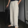 Men's light-weight apricot coloured cotton linen trousers with a loose Korean fit and pencil leg opening.