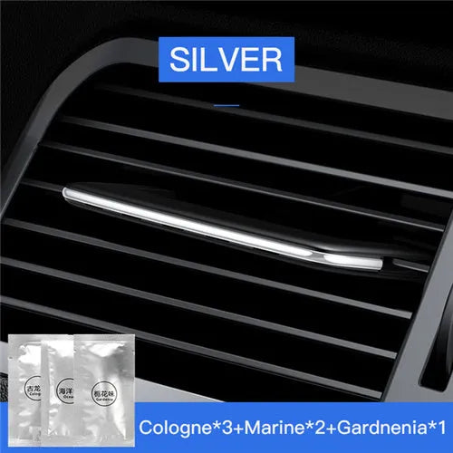 Pick-up car aroma clip in black attached to a car air vent diffusing a neutral scent