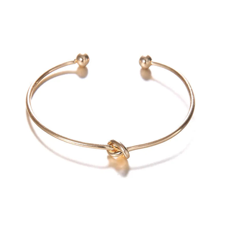 Women's gold vintage cuff bracelet with knotted arrow design in alloy with electroplated finish