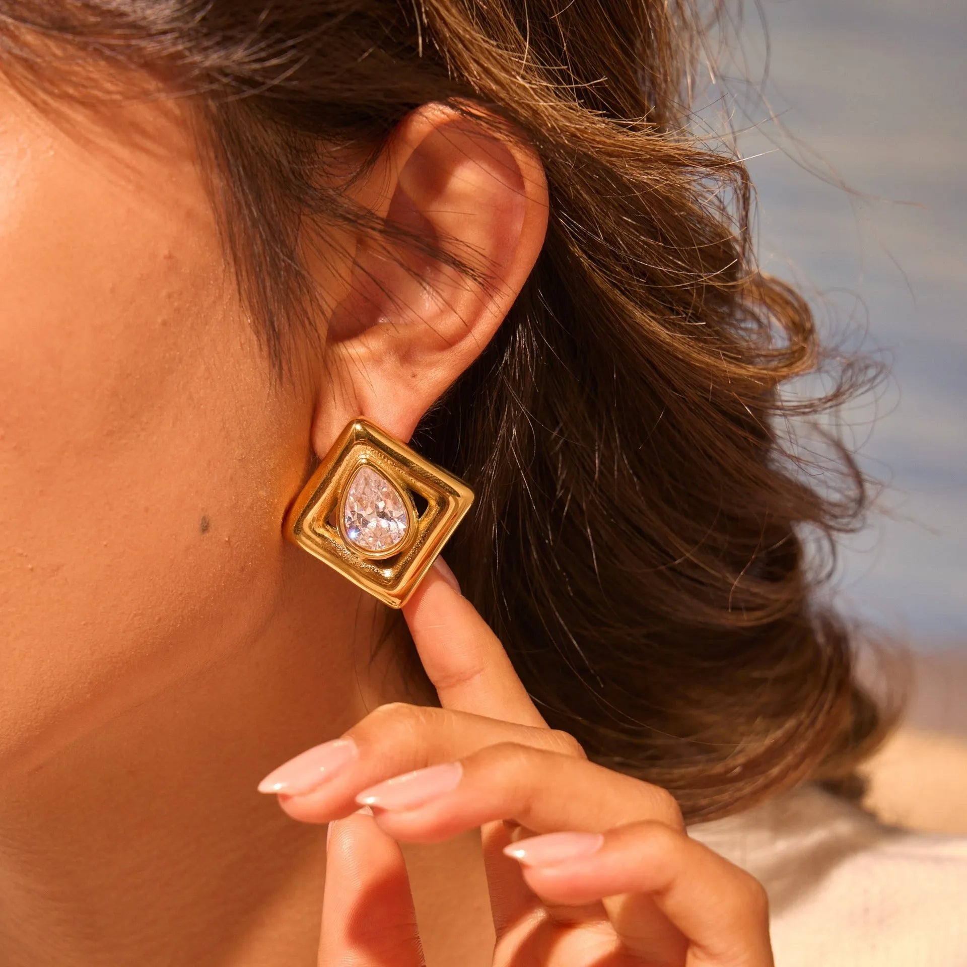 Gold plated geometric stud earrings with water drop zircon inlaid design