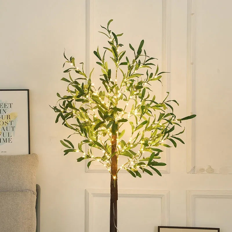 1.8 metre tall artificial olive tree lamp with warm LED lights illuminating courtyard decoration