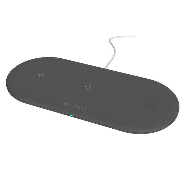 Black and white 3-in-1 wireless charging station for iPhone, Apple Watch and AirPods on a desk.