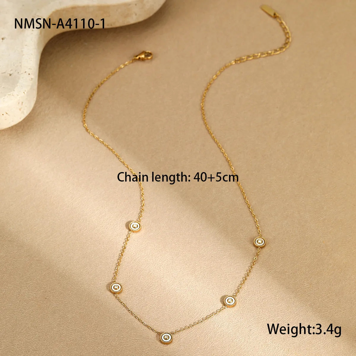 Close-up of a women's geometric fritillary pattern bracelet and necklace set in gold-plated stainless steel.