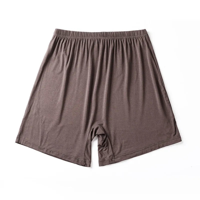 Men's solid colour modal boxers on a white background, showing high-waist design in black, blue, and gray.