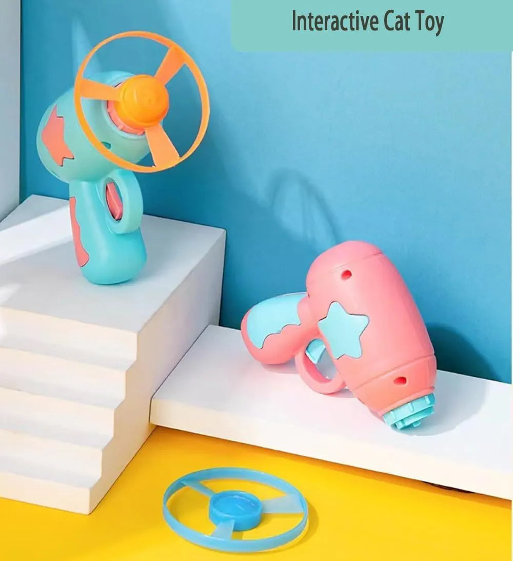 Blue or pink plastic cat toy gun launcher with spinning Frisbee for indoor cat play.