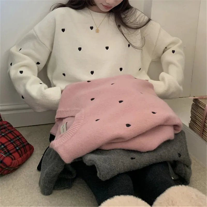 Women's loose fit grey acrylic pullover sweater with embroidery on the front.