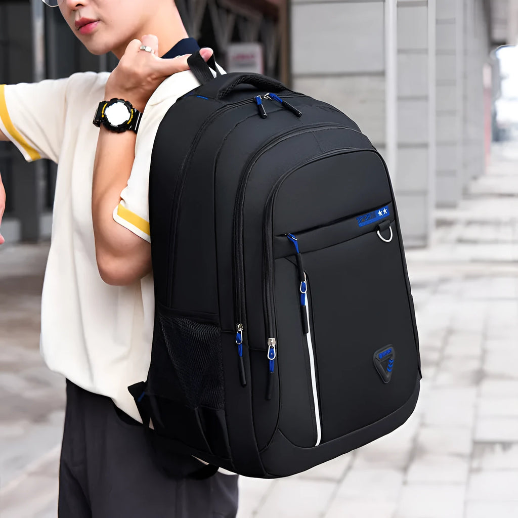 Men's Oxford cloth schoolbag in black with letter pattern, showing large capacity and air pillow shoulder straps.