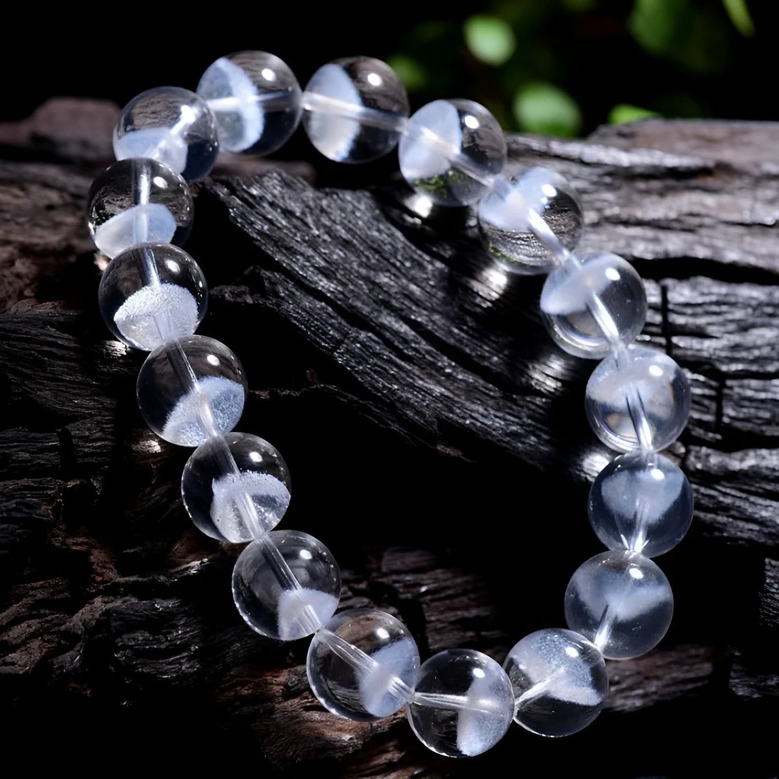 Women's white crystal pyramid bead bracelet with a silver ruyi charm on a white background.