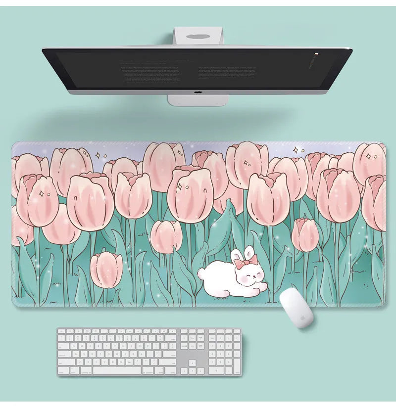Large floral pattern mouse pad on a desk, showing non-slip rubber base and thin cloth surface.