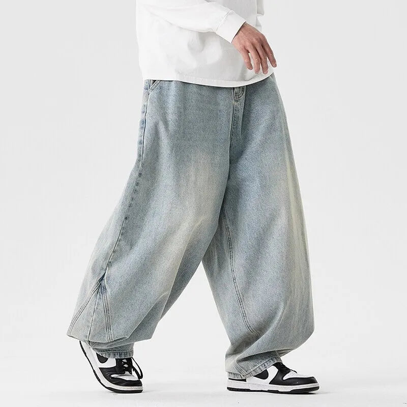 Men's loose-fit straight leg jeans in black denim on a hanger.