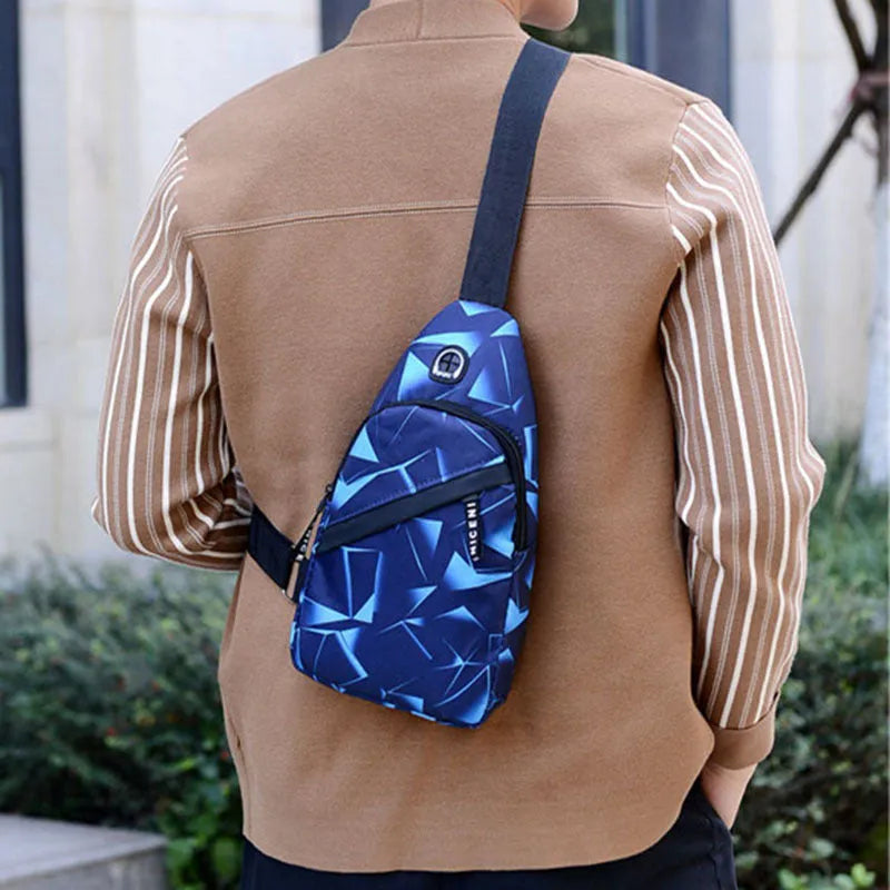 Men's black print sling chest bag with earphone hole and zipper, showing inner patch pocket.