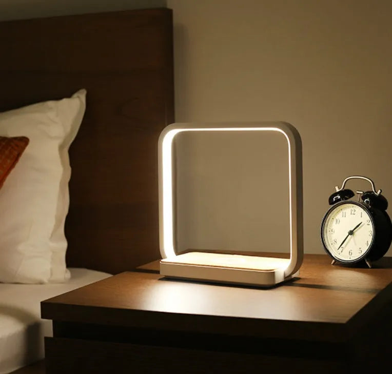 White plastic touch control LED lamp compatible with iPhone on a nightstand