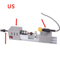 Compact silver metal mini manual woodworking lathe with carving knives on a benchtop