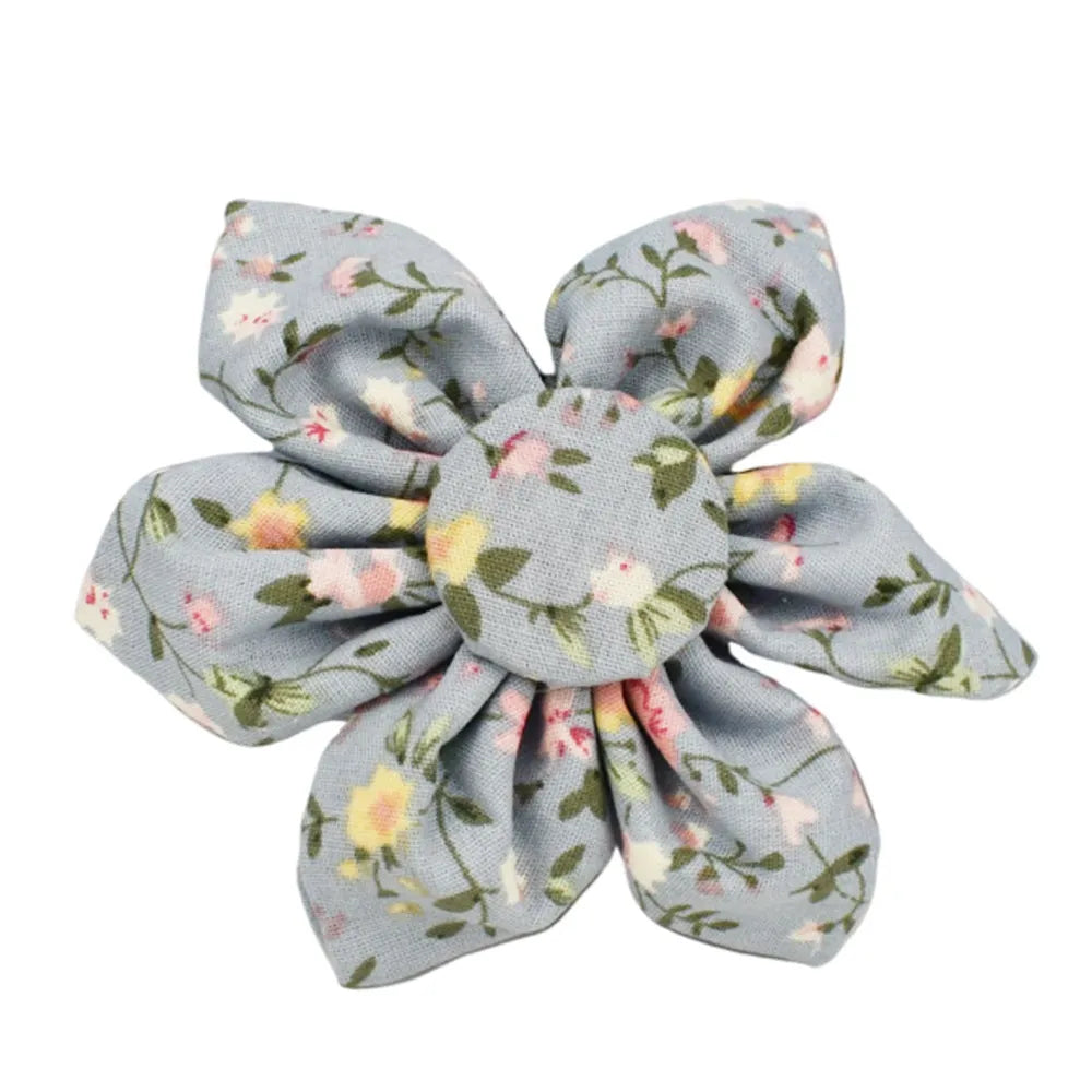 Blue floral patterned dog collar and matching leash, vest, and bow set on a white background.