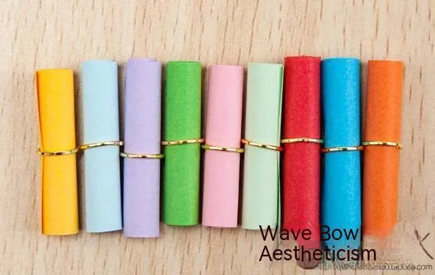 Assorted coloured mini paper scrolls with metal eyelets in sizes 3x7cm, 4x7cm, 5x5cm and 7x7cm.