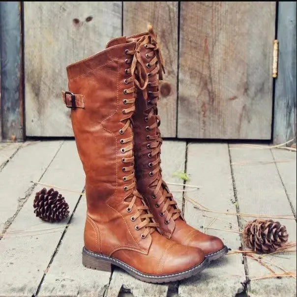 Black chunky heel high leg ankle boots with round toe and low block heel on a plain background.