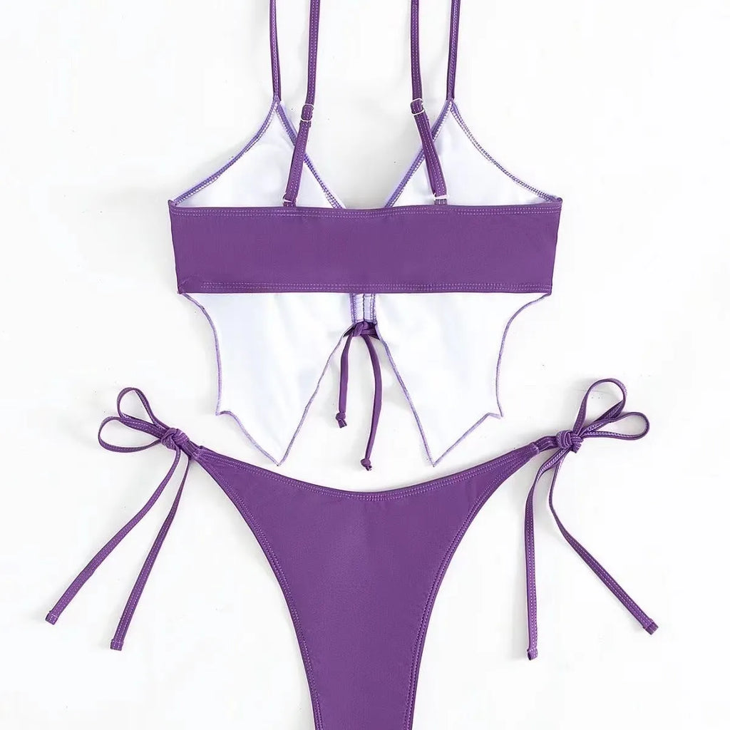 Women's purple bikini suit with bow ins style detail on a split design, made from polyester fabric.