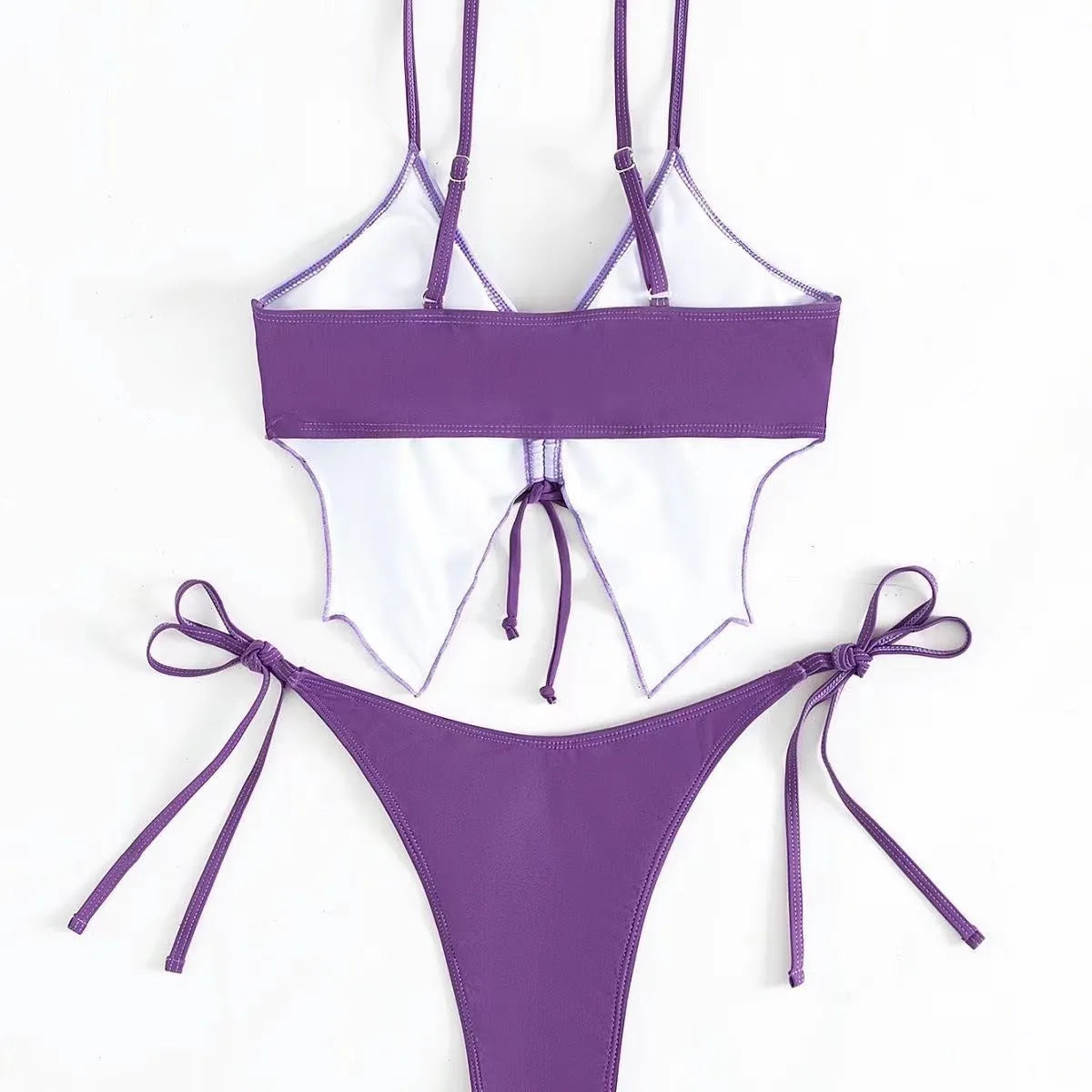 Women's purple bikini suit with bow ins style detail on a split design, made from polyester fabric.