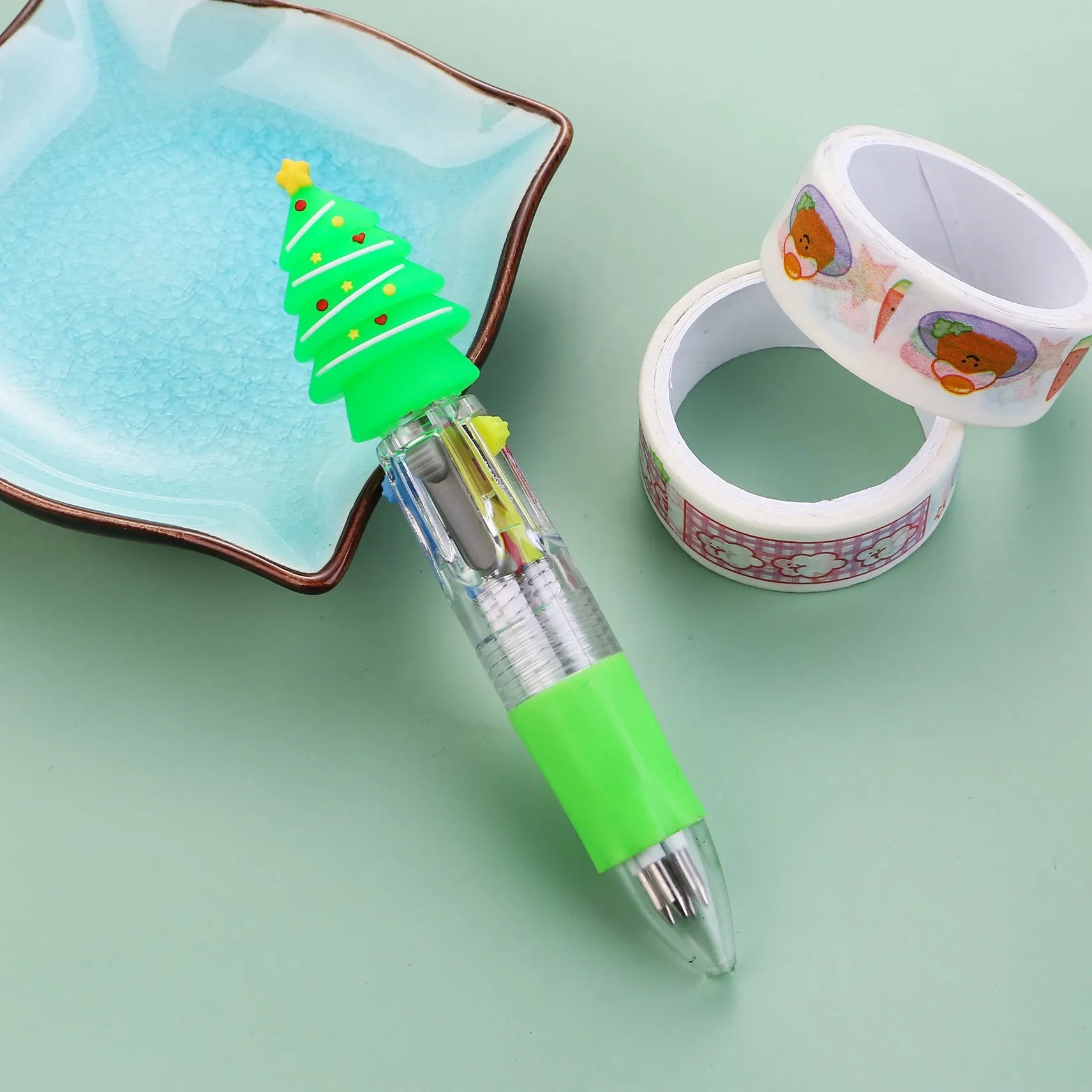 Christmas mini four-colour press-type ballpoint pen showing festive designs, 11cm long.