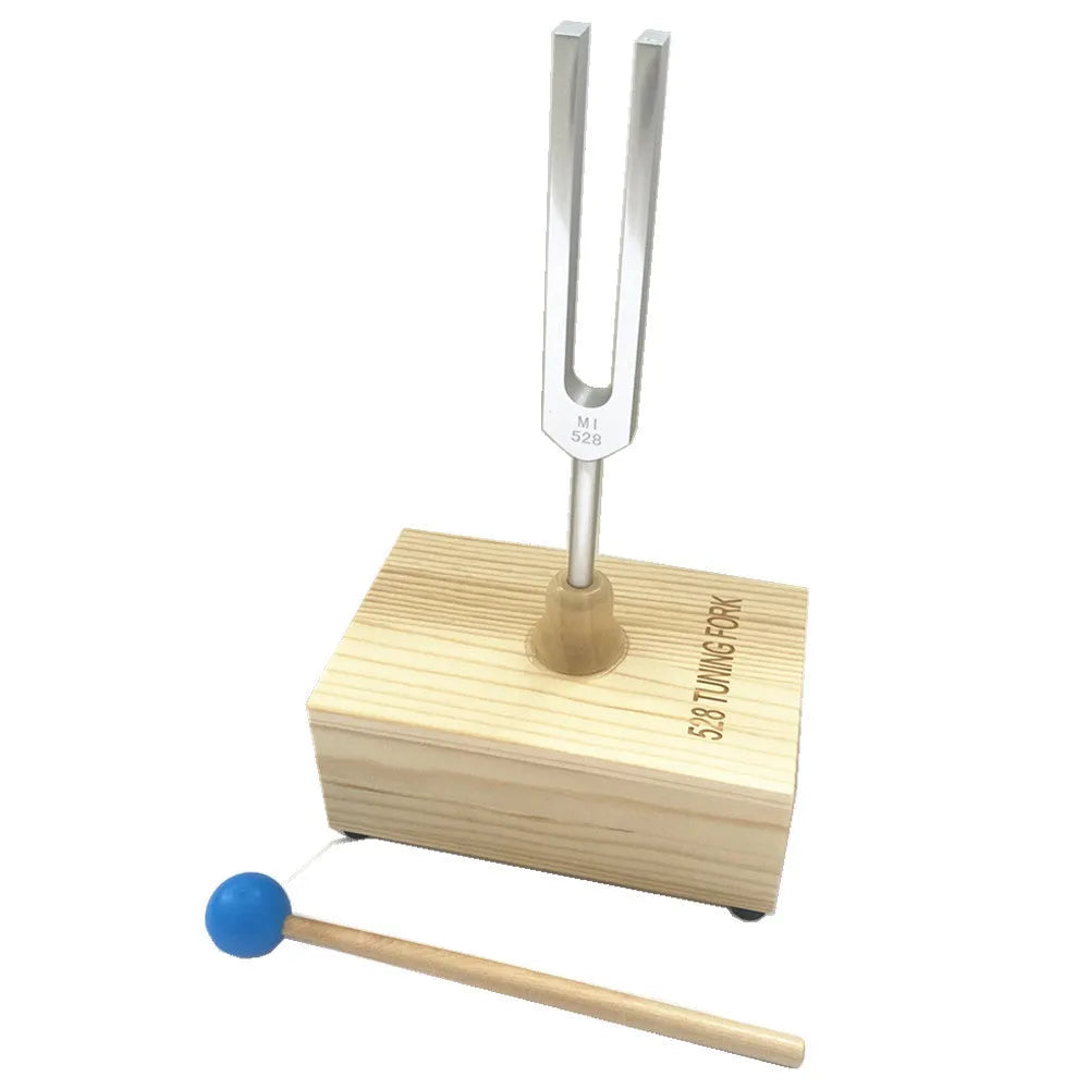 Aluminium alloy 432Hz tuning fork with speaker on kraft paper box background