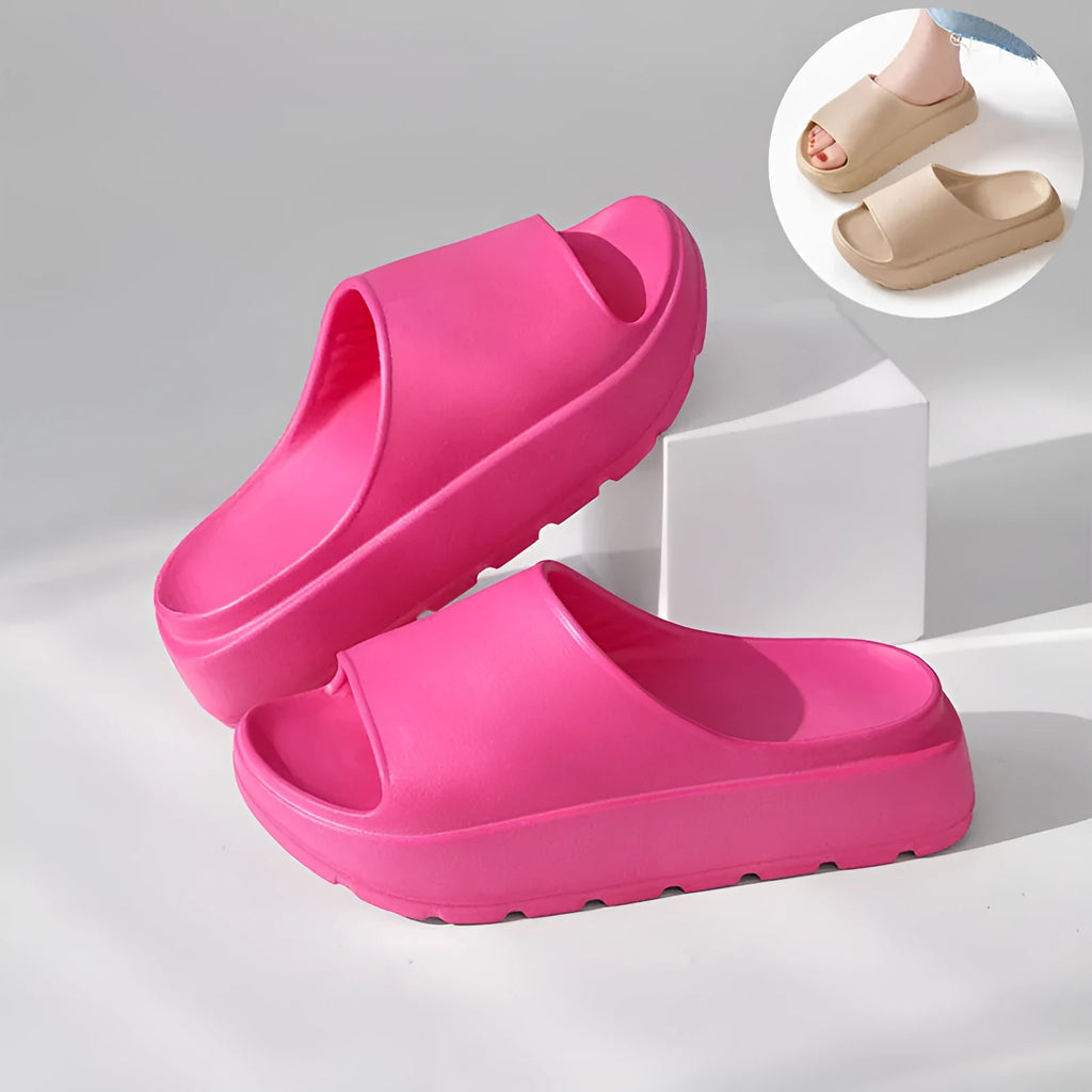 Women's beige fish mouth slippers with a thick 5.5cm EVA platform sole on a wooden floor.
