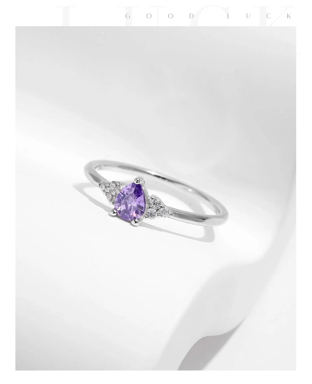 S925 sterling silver ring with purple crystal drop-shaped rhinestone on white background