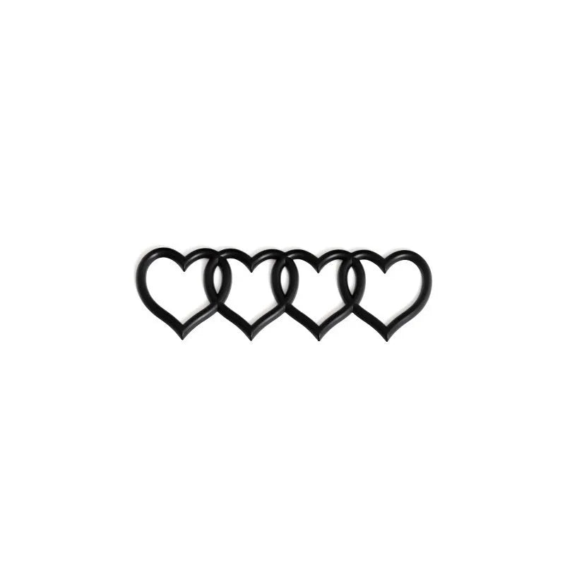Heart-shaped body sticker with four-ring tail design in electroplated silver colour on a car bumper