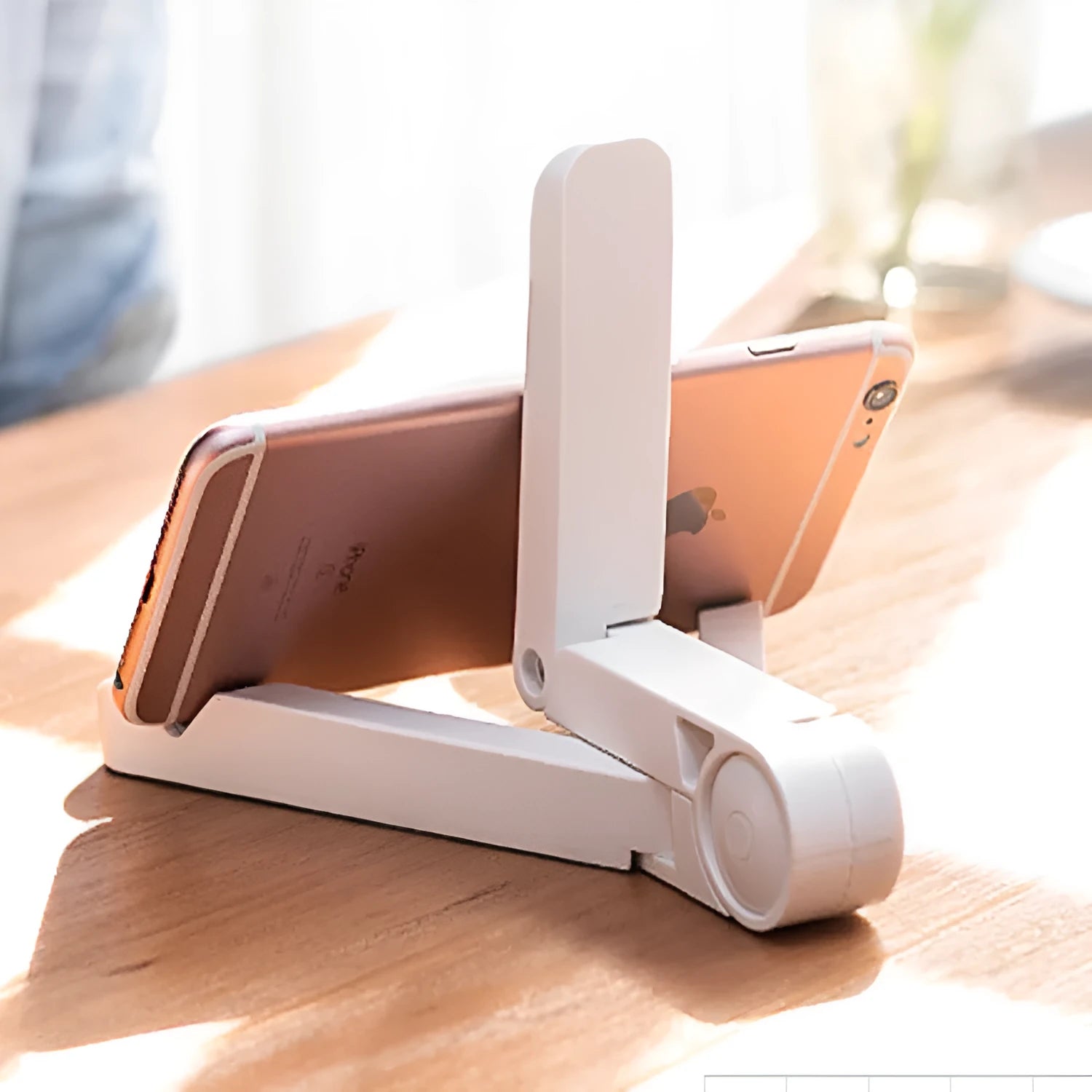 Black foldable aluminium tablet holder showing adjustable stand in open and closed positions on a desk.