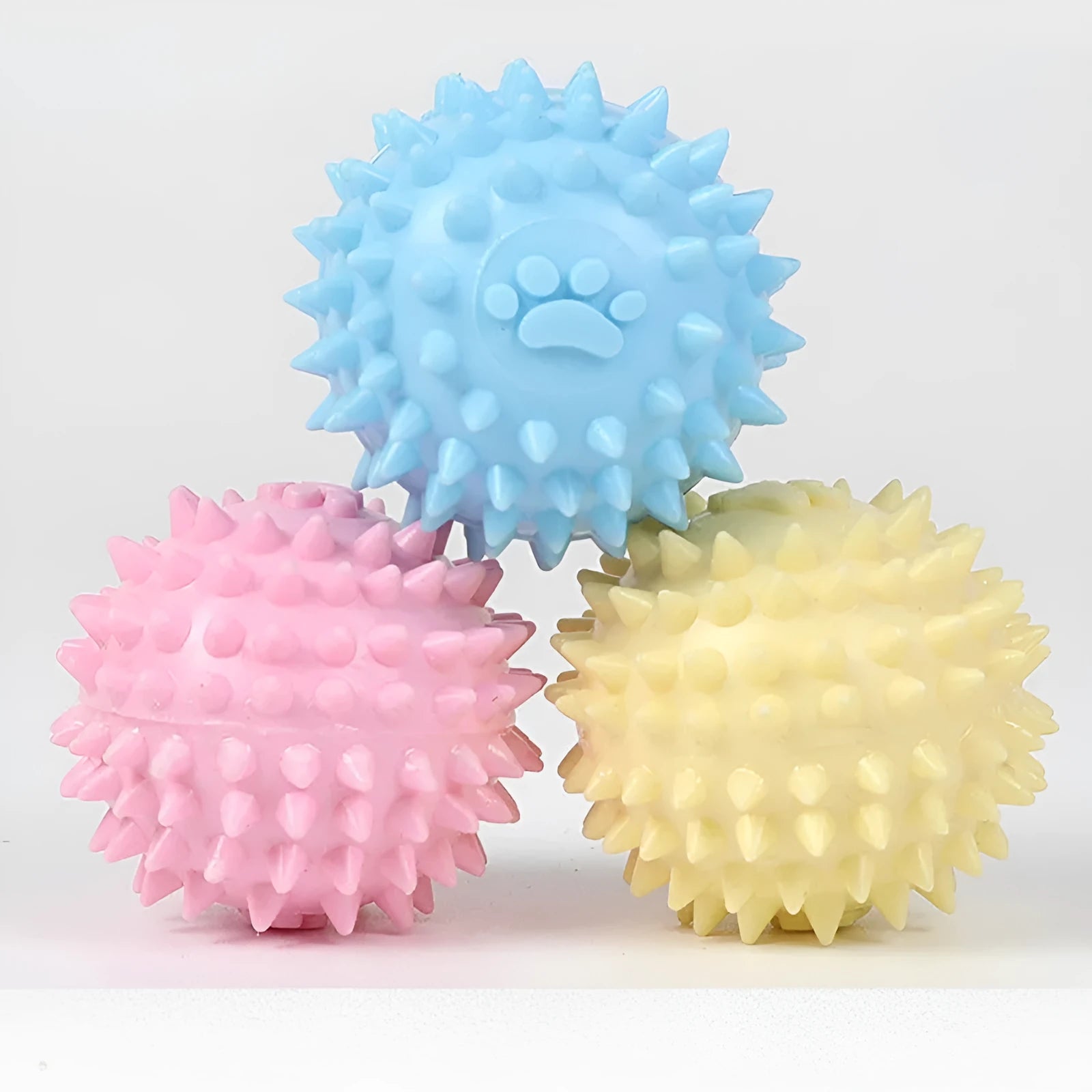 Blue TPR dog chew ball with footprint texture, 6cm diameter, for tooth cleaning and play.
