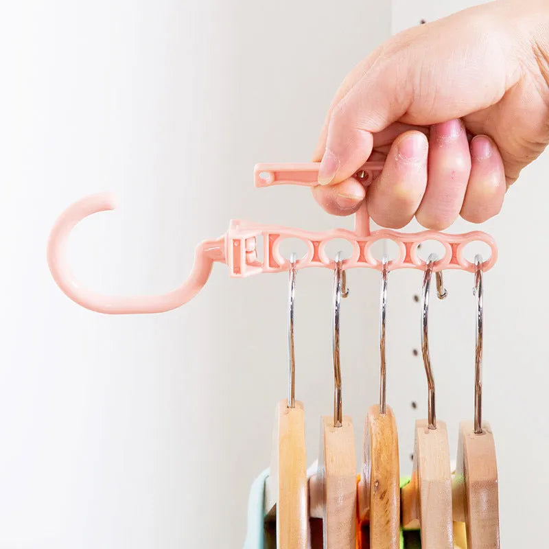 Blue revolving wardrobe hanger with five hooks and a central white handle for easy rotation