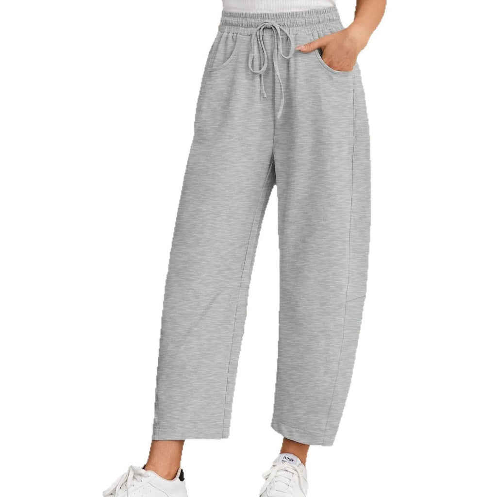 Loose cropped sweatpants with elastic drawstring waist in cotton fabric, shown in multiple colour options