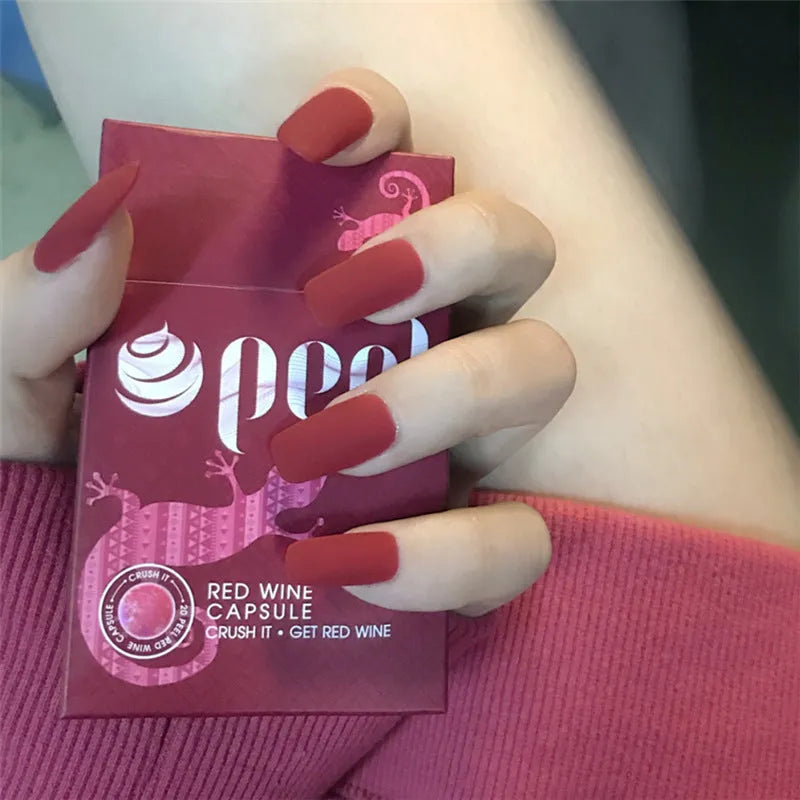 24 false nails in matte red medium length with glue adhesive in packaging