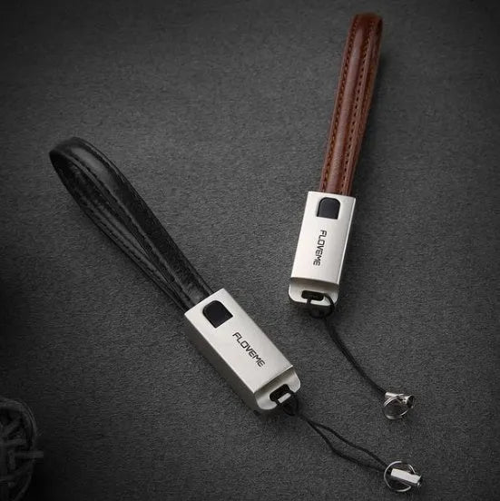 Short red leather braided USB-C to Apple Lightning charging cable on a white background