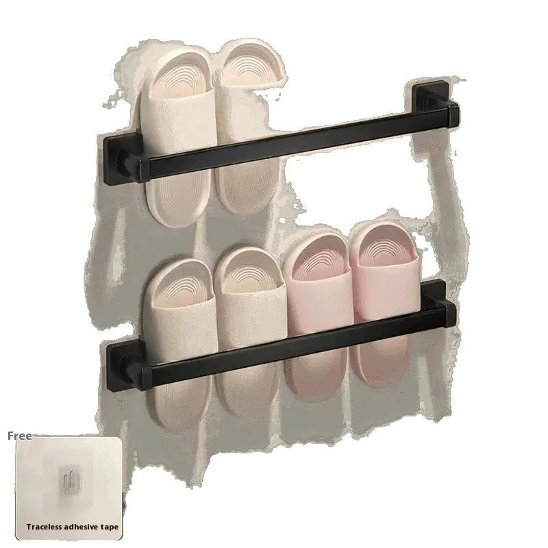 Black wall-mounted bathroom slipper rack with an integrated small seat, shown on a tile wall.