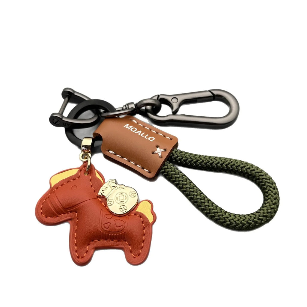 Handmade brown cowhide key pendant with a green flannel rope and a gold-toned horse-shaped buckle.