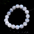 Natural blue moonlight round bead moonstone bracelet on a wrist, showing polished geometric beads.