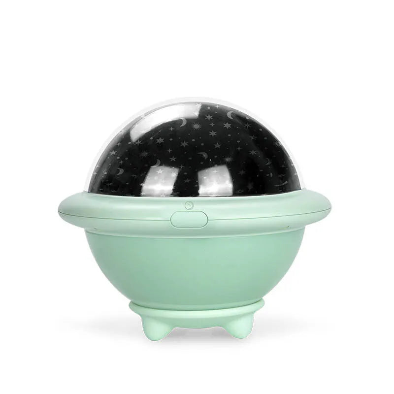 Green UFO-shaped starry sky projection night light with LED lighting on table