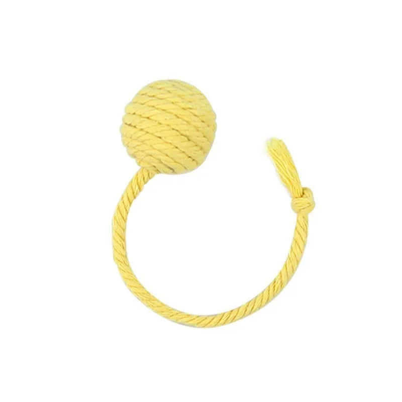 Cat toy ball with attached rope and bell in green, pink, purple or yellow colours showing 6cm and 3cm size comparison