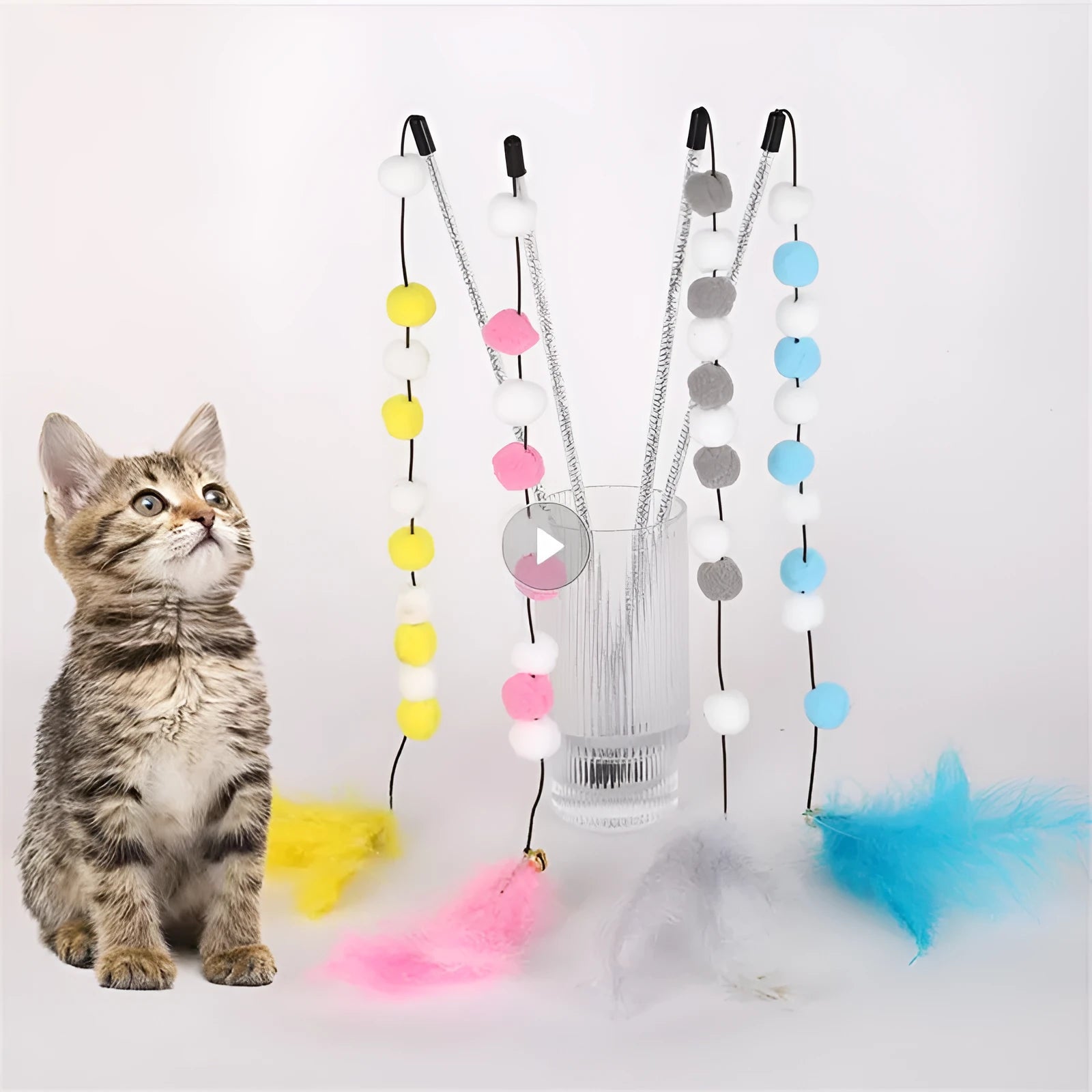 Colourful cat teaser stick with acrylic pompons and feather attachments measuring 31cm long
