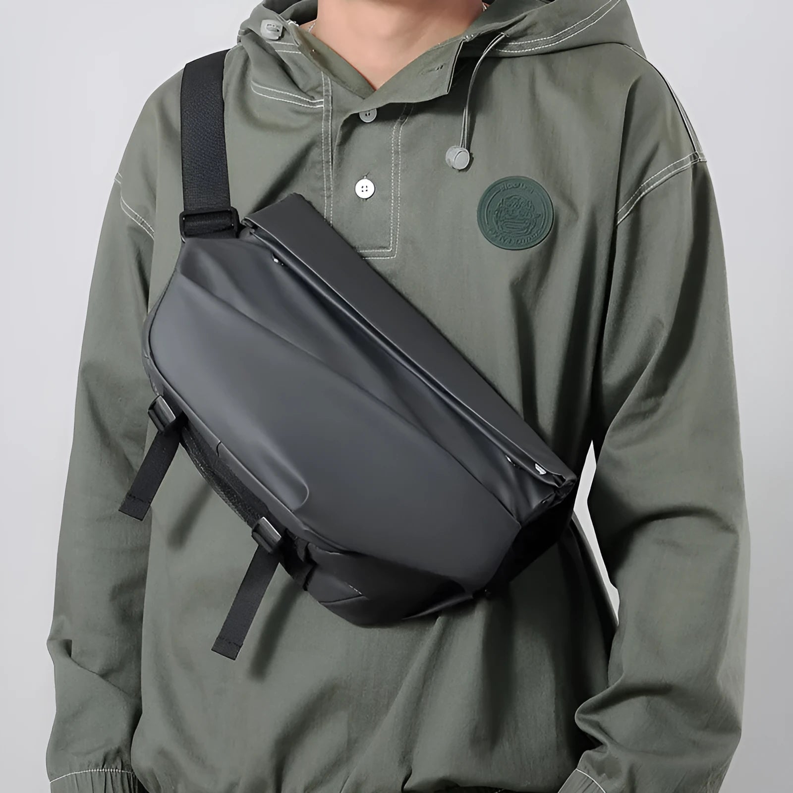 Grey PU leather crossbody sling backpack for men showing horizontal square shape and shoulder strap