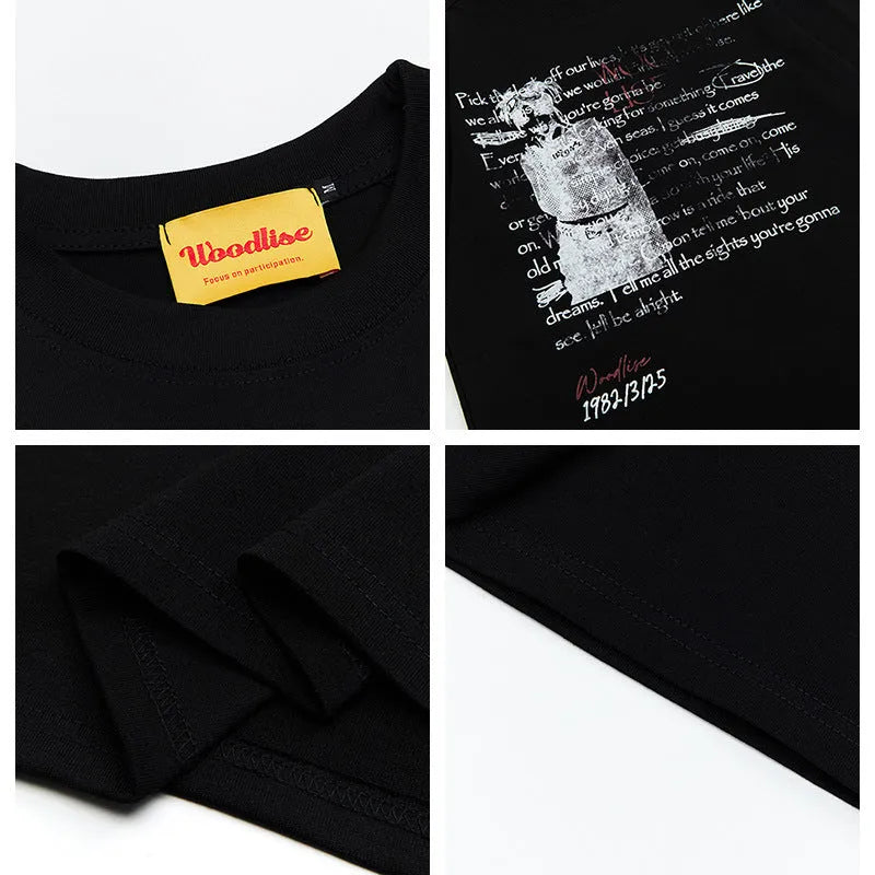 Man wearing a black loose-fit cotton t-shirt with a white retro letter print on the chest.