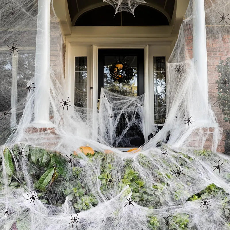 White cotton spider web Halloween decoration with plastic spiders for parties and home displays