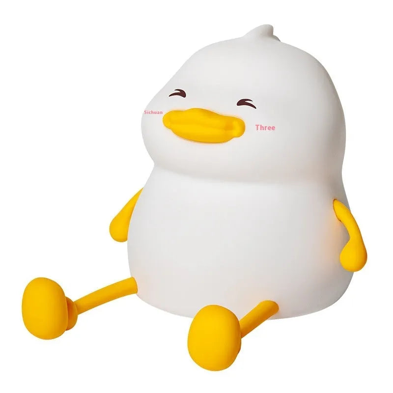 Chubby silicone desktop night light with phone holder showing soft LED illumination