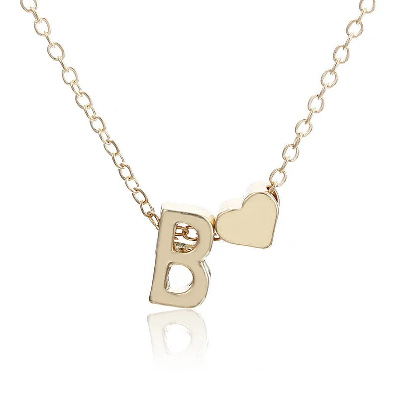 Gold alloy peach heart pendant necklace with a letter detail on a delicate chain.